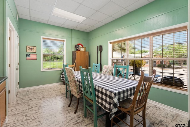 dining space with a drop ceiling