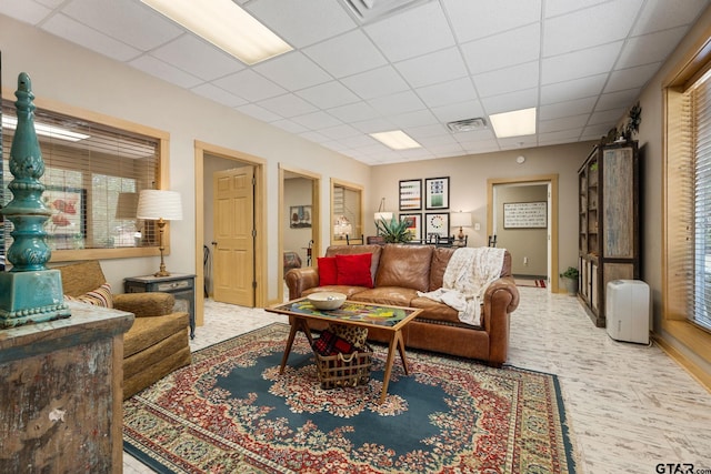 living room featuring a drop ceiling