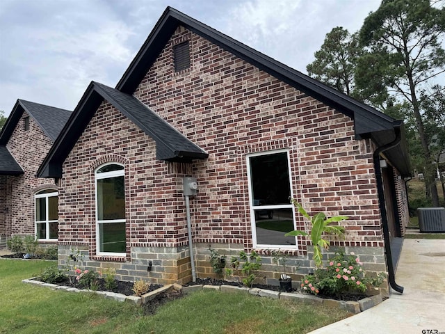 view of front facade with central AC and a front lawn