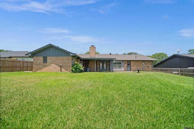 608 Meadow Crk, Tyler, TX 75703 - rear view of house with brick siding, a fenced backyard, and a chimney