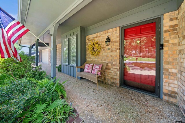 608 Meadow Crk, Tyler, TX 75703 - property entrance featuring brick siding and a porch
