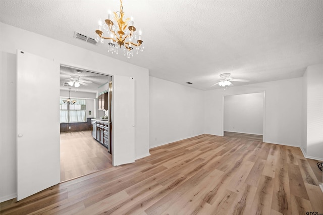 608 Meadow Crk, Tyler, TX 75703 - unfurnished living room with a chandelier, ceiling fan, a textured ceiling, and light wood-style flooring