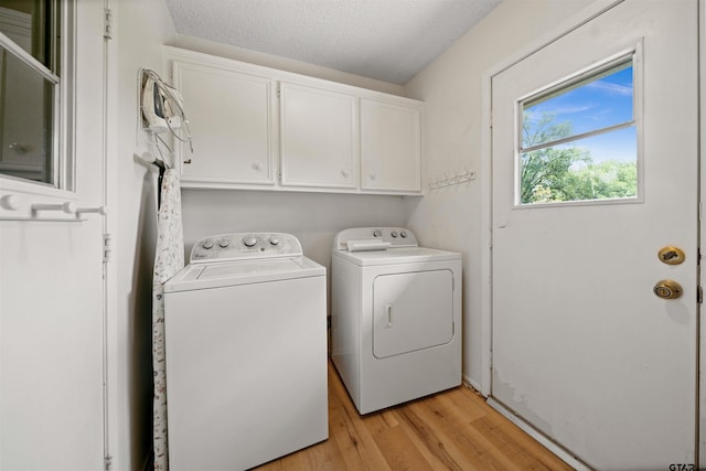 608 Meadow Crk, Tyler, TX 75703 - laundry area with cabinet space, independent washer and dryer, light wood-style floors, and a textured ceiling