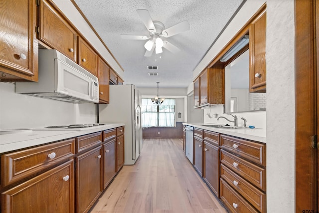 608 Meadow Crk, Tyler, TX 75703 - kitchen featuring white appliances, a textured ceiling, light wood-type flooring, a ceiling fan, and light countertops