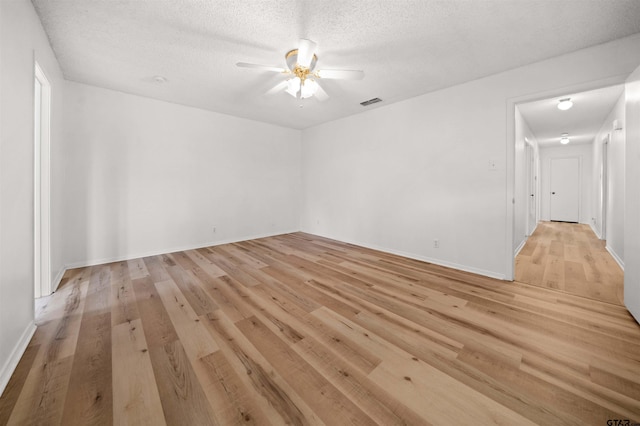 608 Meadow Crk, Tyler, TX 75703 - empty room featuring ceiling fan, light wood-style flooring, and a textured ceiling
