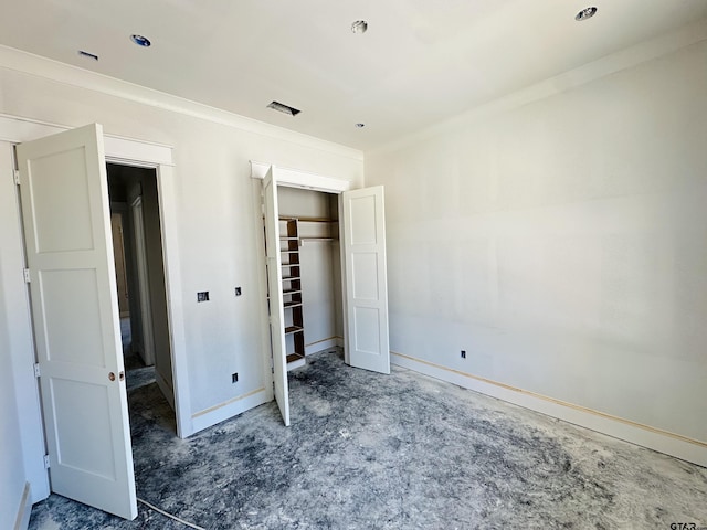 unfurnished bedroom with a closet and baseboards