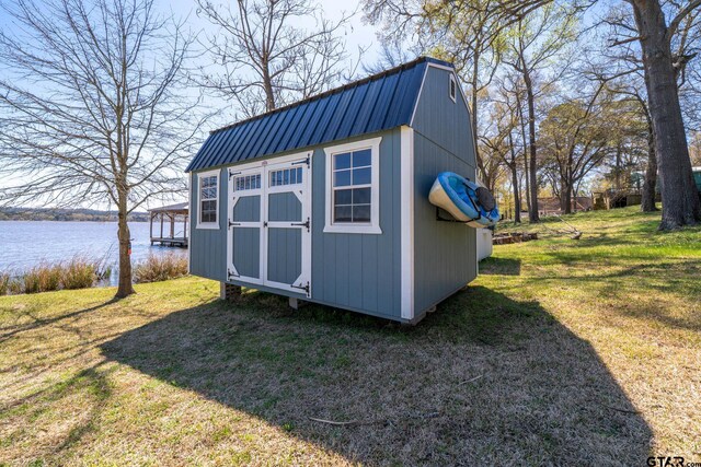 view of shed with a water view