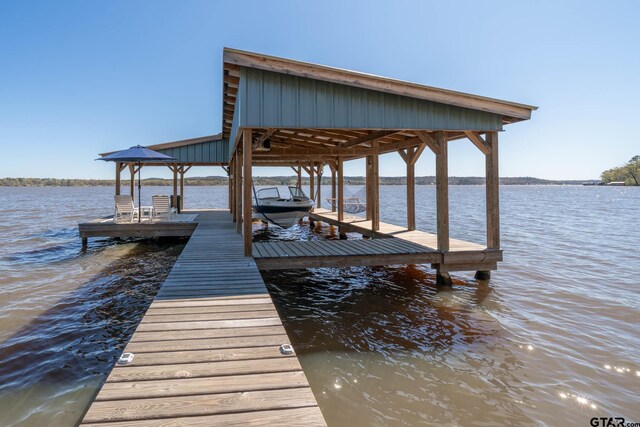 view of dock featuring a water view and boat lift