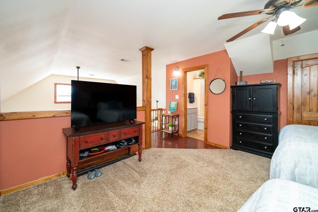 carpeted living room with ceiling fan and vaulted ceiling