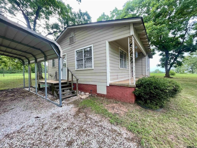 129 An County Rd 302, Frankston, TX 75763 - view of side of home featuring a yard, a detached carport, and driveway