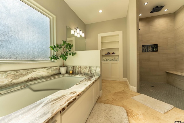 bathroom featuring built in shelves, recessed lighting, a bath, and a walk in shower