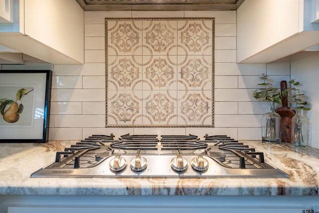 room details featuring stainless steel gas stovetop and decorative backsplash