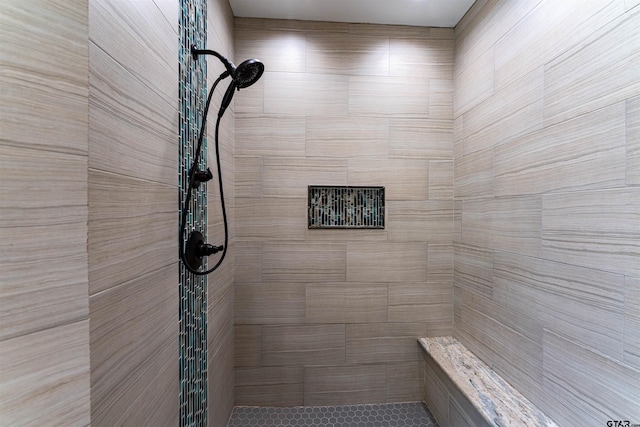 bathroom with a tile shower