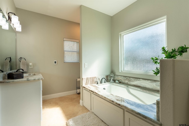 full bathroom with tile patterned flooring, baseboards, a bath, and vanity