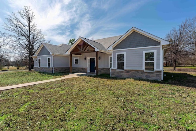 craftsman inspired home featuring board and batten siding, stone siding, and a front lawn