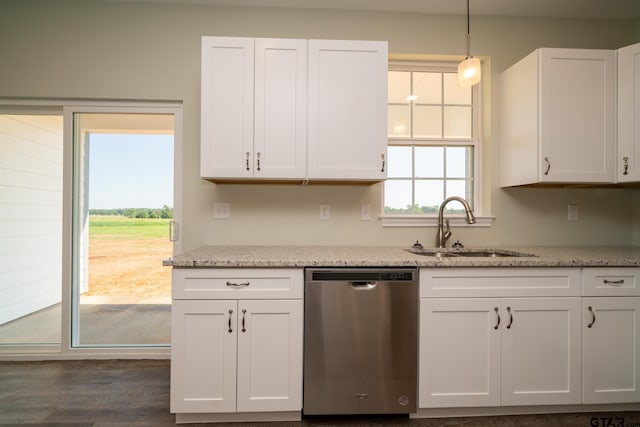 kitchen featuring stainless steel dishwasher, light stone countertops, white cabinets, and decorative light fixtures