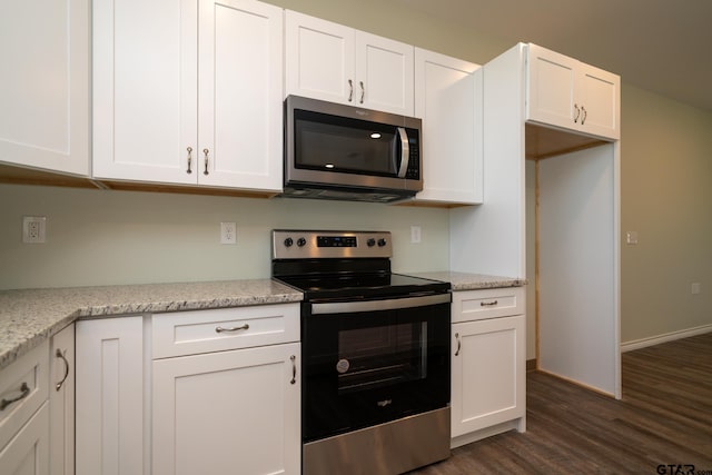 kitchen with white cabinetry, light stone countertops, dark hardwood / wood-style floors, and stainless steel appliances