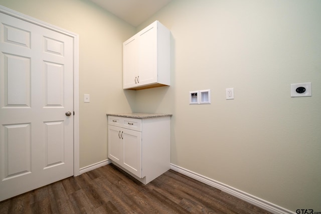 laundry area featuring hookup for an electric dryer, dark wood-type flooring, and cabinets