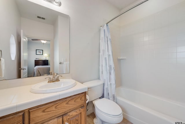 full bathroom featuring vanity, shower / bathtub combination with curtain, and toilet