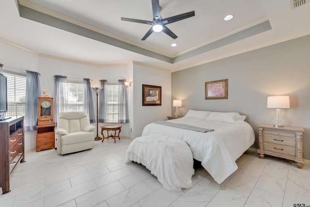 bedroom featuring a tray ceiling, ceiling fan, and crown molding