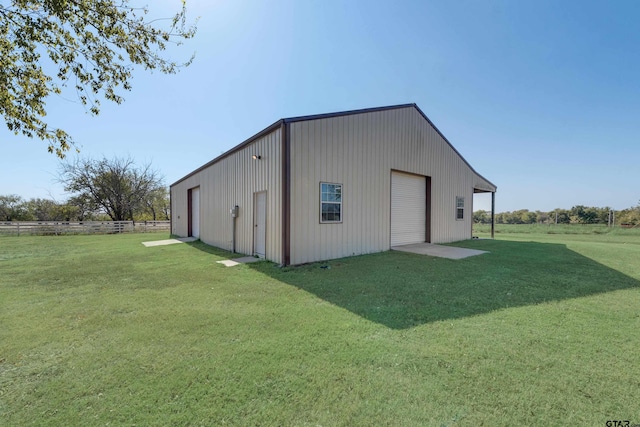 view of outdoor structure with a garage and a yard