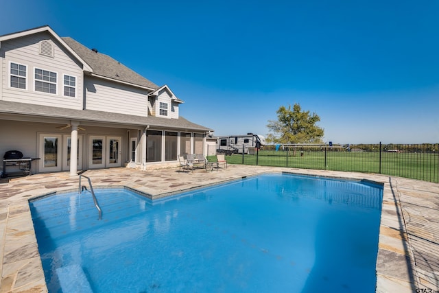 view of pool with a sunroom, a patio area, area for grilling, and ceiling fan