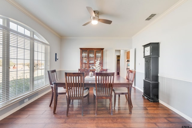 dining room with dark wood-type flooring, ceiling fan, plenty of natural light, and ornamental molding