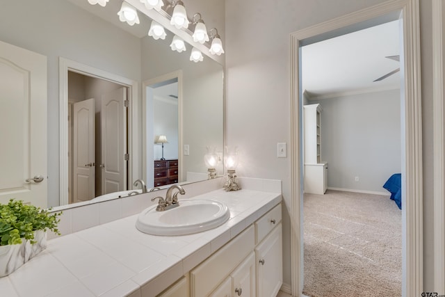 bathroom with ornamental molding and vanity