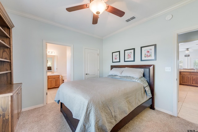 bedroom featuring ornamental molding, light colored carpet, ceiling fan, and ensuite bathroom