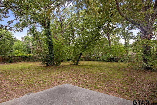 view of yard featuring fence and a patio