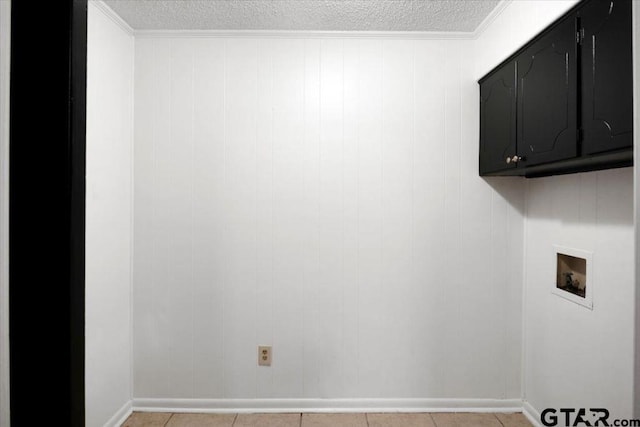 washroom featuring baseboards, hookup for a washing machine, cabinet space, and a textured ceiling