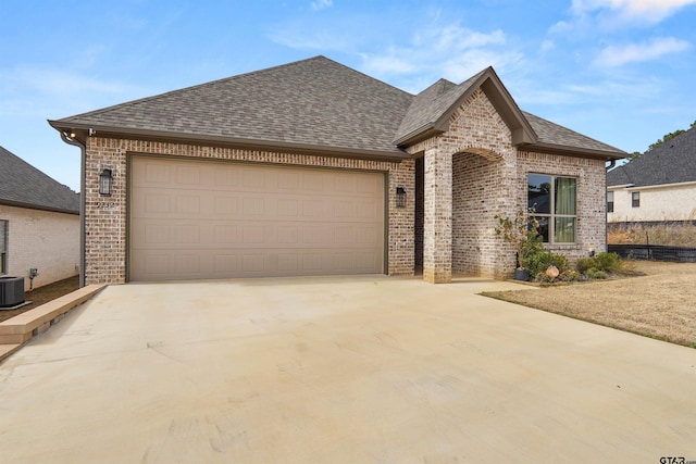 french country inspired facade featuring a garage