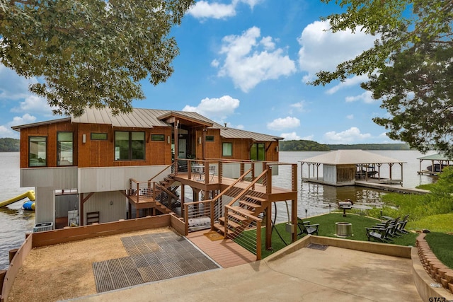 16822 Perry St, Tyler, TX 75707 - rear view of house featuring a water view, stairway, a standing seam roof, and a yard