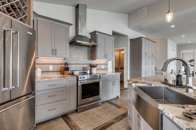 16822 Perry St, Tyler, TX 75707 - kitchen featuring gray cabinetry, high quality appliances, wall chimney exhaust hood, decorative backsplash, and recessed lighting