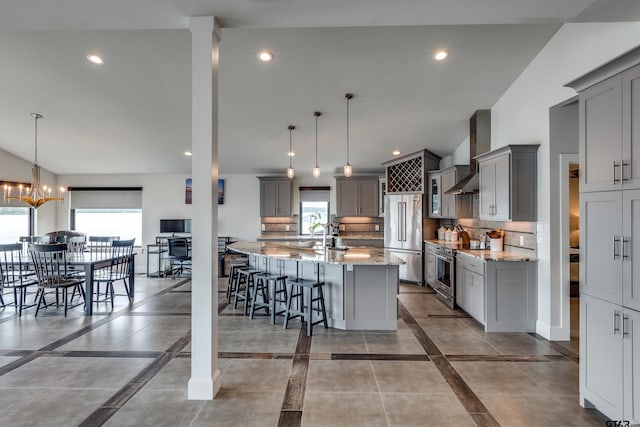 16822 Perry St, Tyler, TX 75707 - kitchen featuring gray cabinets, premium appliances, wall chimney exhaust hood, light stone counters, and recessed lighting