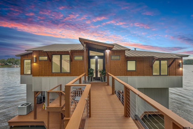 16822 Perry St, Tyler, TX 75707 - back of house at dusk with french doors, a water view, a metal roof, and stairway
