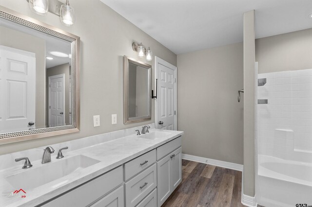 108 Benny St, Longview, TX 75604 - bathroom featuring double vanity, wood finished floors, baseboards, and  shower combination