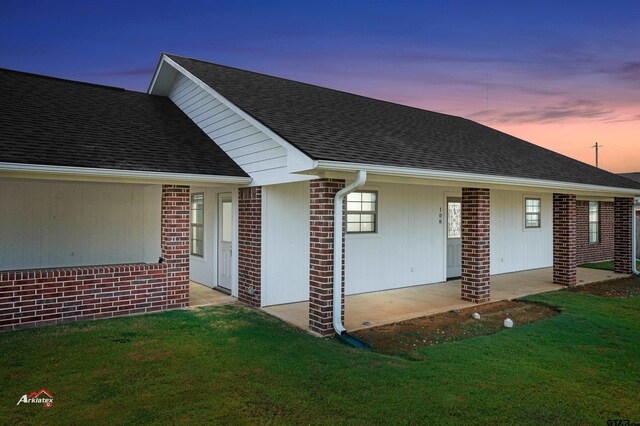 108 Benny St, Longview, TX 75604 - view of front of house featuring a front yard, brick siding, and a shingled roof