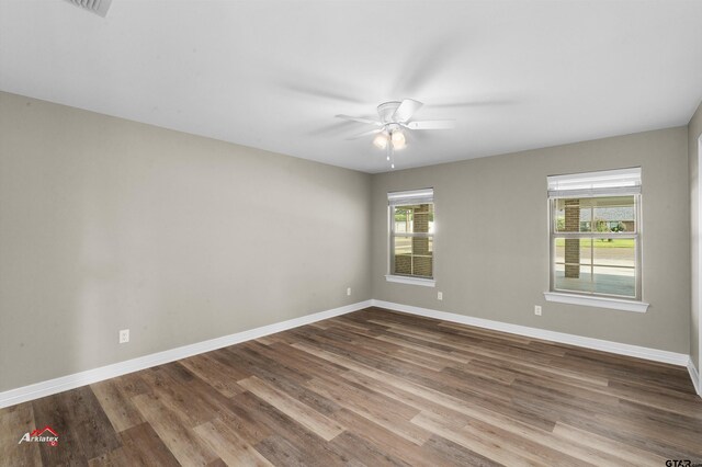 108 Benny St, Longview, TX 75604 - unfurnished room with wood finished floors, ceiling fan, and baseboards