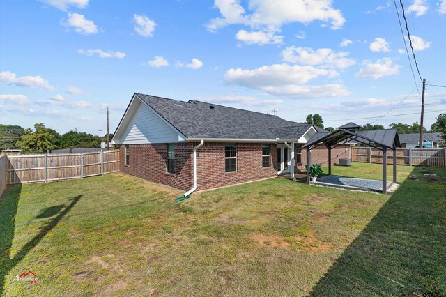 108 Benny St, Longview, TX 75604 - back of house with brick siding, a gazebo, a shingled roof, and a patio area