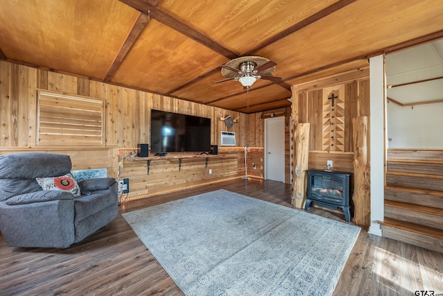 living room featuring a wood stove, wood-type flooring, wood walls, and wood ceiling