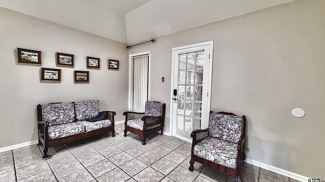 sitting room featuring lofted ceiling and light tile patterned floors