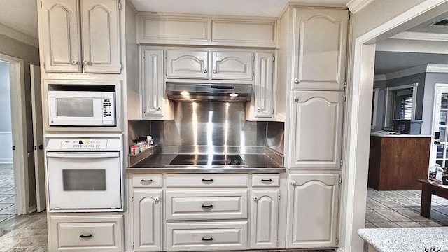 kitchen with crown molding, white appliances, and decorative backsplash