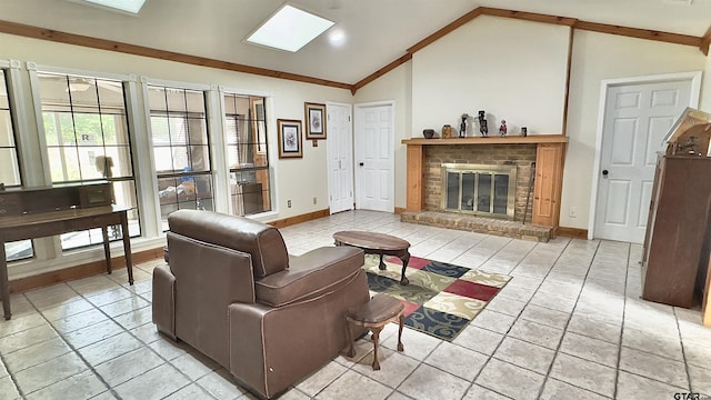 living room featuring vaulted ceiling with skylight and a brick fireplace