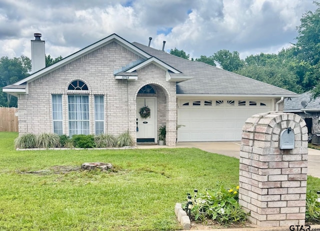 10764 Southern Trace Cir, Flint, TX 75762 - view of front of house with brick siding, a chimney, a garage, roof with shingles, and concrete driveway
