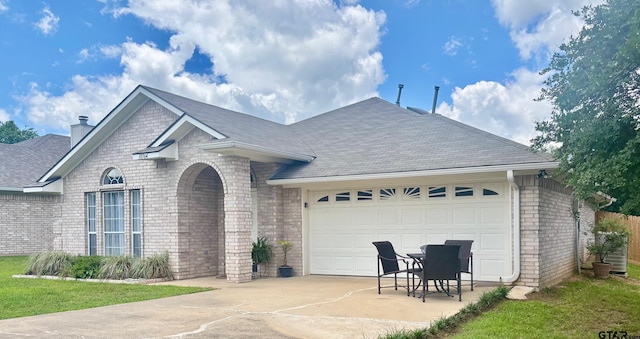 10764 Southern Trace Cir, Flint, TX 75762 - view of front of house featuring brick siding, concrete driveway, a garage, roof with shingles, and a chimney