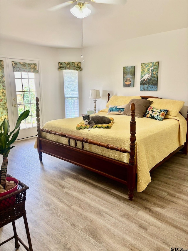10764 Southern Trace Cir, Flint, TX 75762 - bedroom featuring light wood-style floors, access to exterior, and a ceiling fan