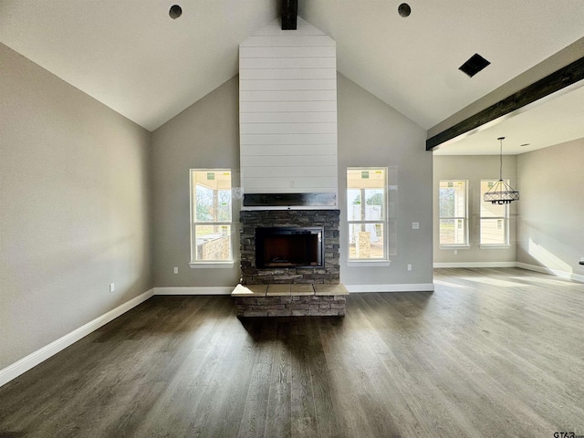 unfurnished living room featuring vaulted ceiling with beams, dark hardwood / wood-style flooring, and a stone fireplace