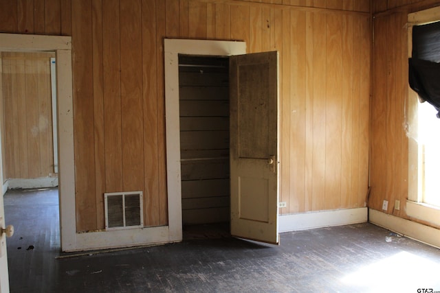 empty room featuring wooden walls