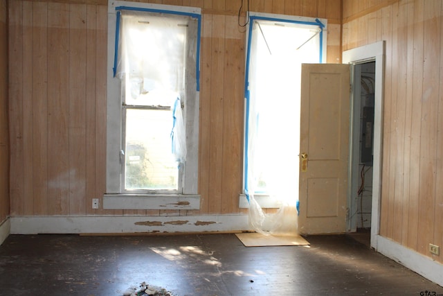 miscellaneous room featuring wood walls